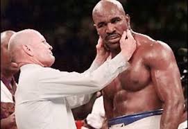 Referee inspecting Hollifields bite from Tyson